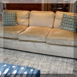 F18. Cream colored sofa. 32”h x 90”w x 40”d 